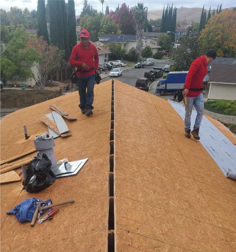 roofers from av roofing pro èrforming a re-roof in woodland, ca